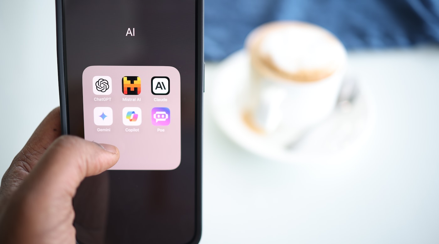 A smartphone showing a folder of AI chat apps including ChatGPT