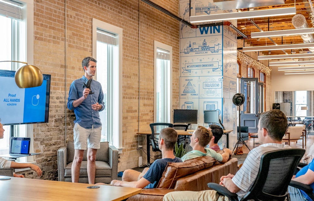 A marketing team gathered around a strategy session discussing how they win customers