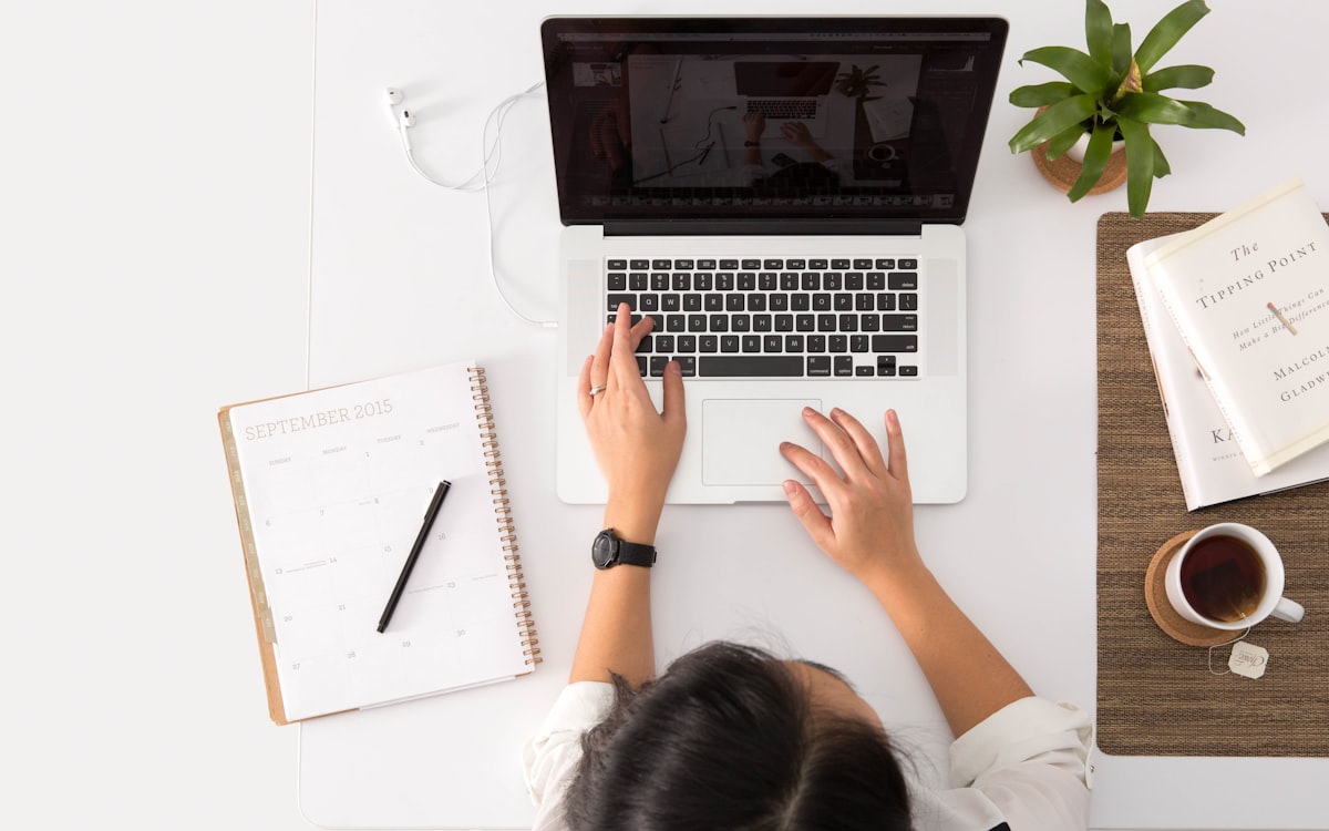 Someone researching competitors and keywords on a laptop at a tidy desk