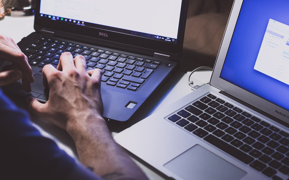 A person typing a search query into a laptop to run Google search operators