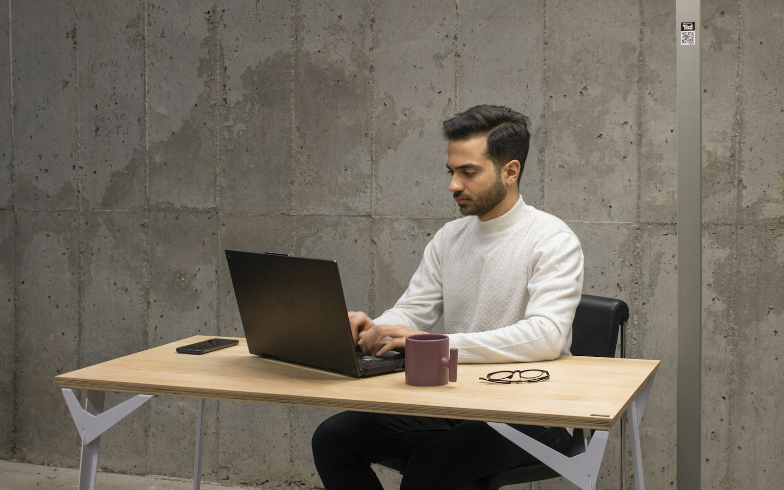A person writing ad copy on a laptop at a desk
